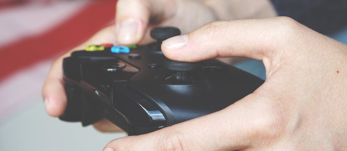 Man playing video games, one of the most common forms of transfer addiction.