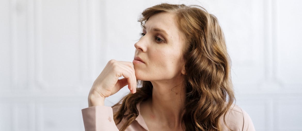 Woman thinking while in a therapy session.