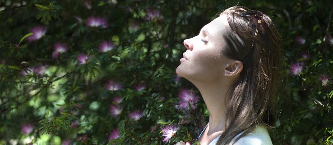 Woman practicing deep breathing techniques.