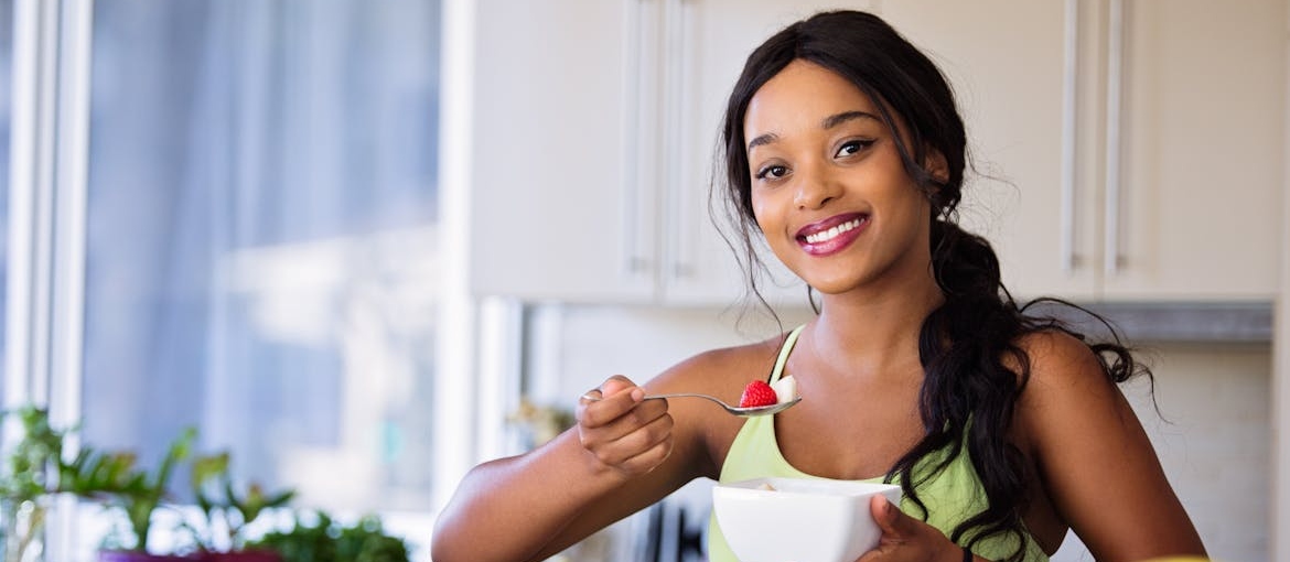 Woman eating a fruit salad.