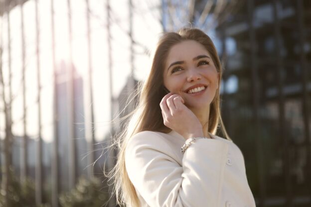 Woman making a phone call and experiencing benefits of sobriety.