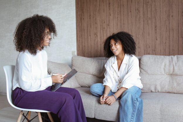 Woman going through principles of CBT with her therapist.