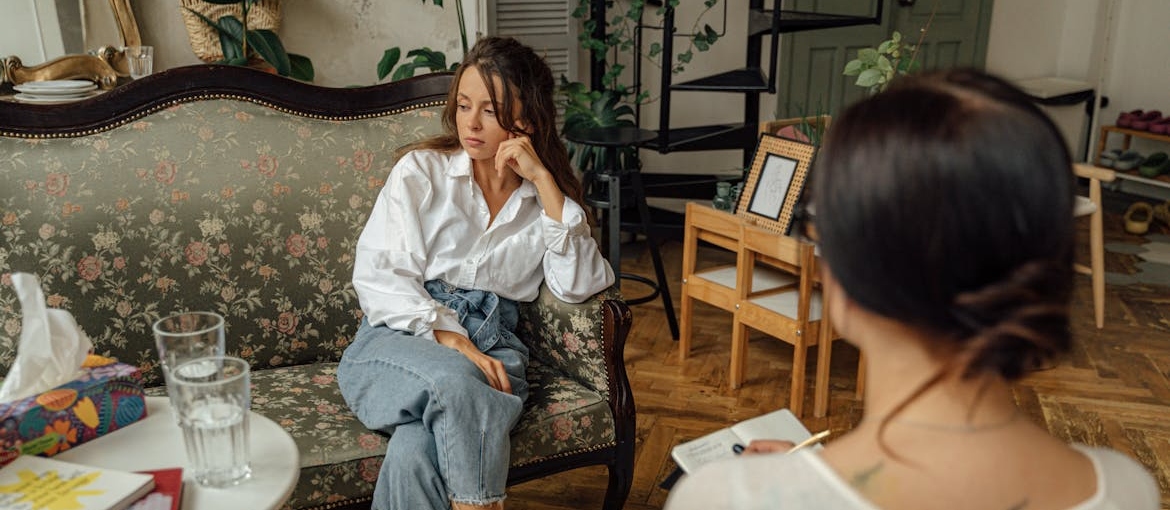 Woman going through principles of CBT with her therapist.