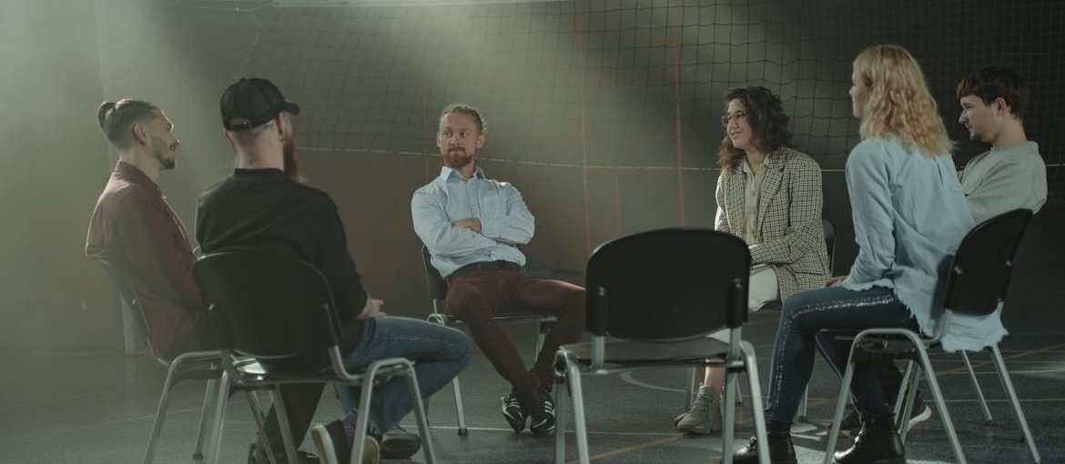 People in a support group talking about benefits of sobriety.