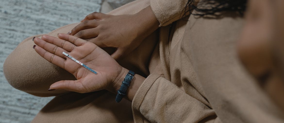 Woman holding a testing strip meant to test the presence of fentanyl laced heroin.