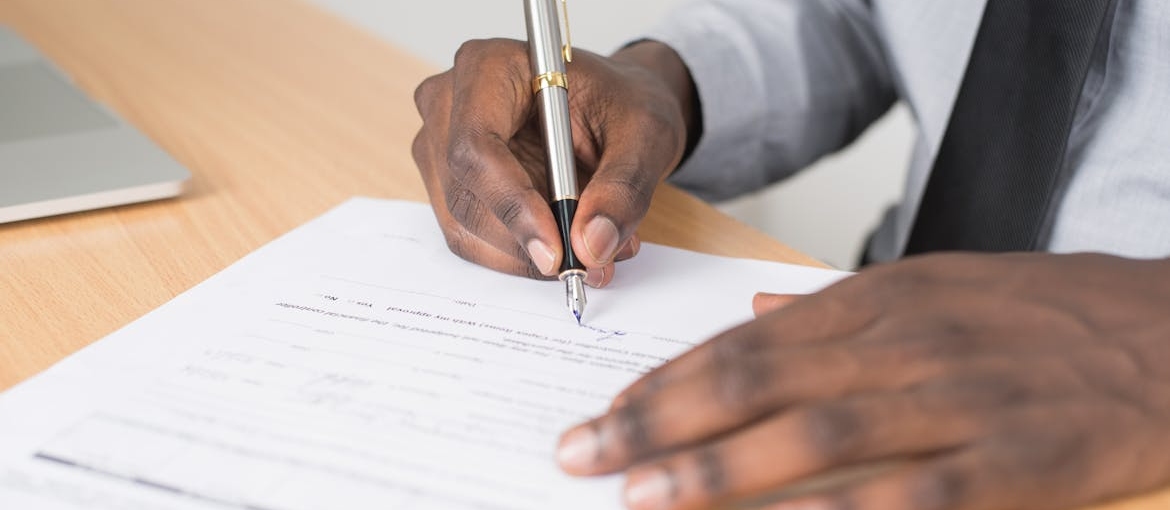 Man signing a contract.