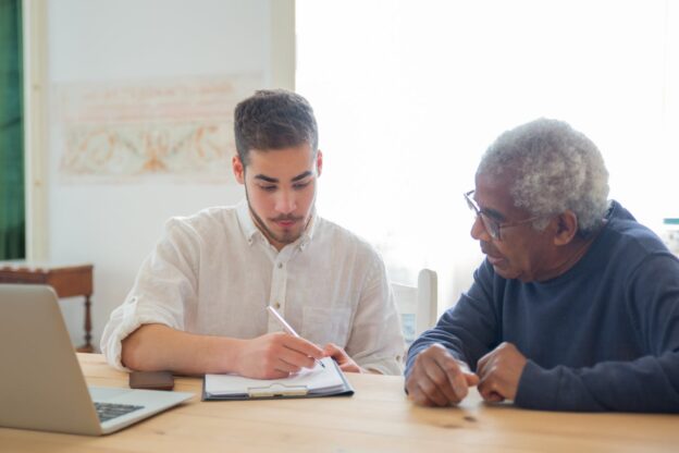 Young man talking with an elderly man.