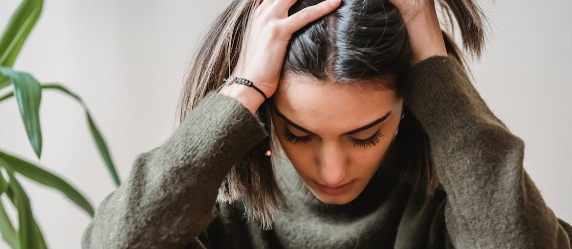 Anxious woman pulling up her hair.