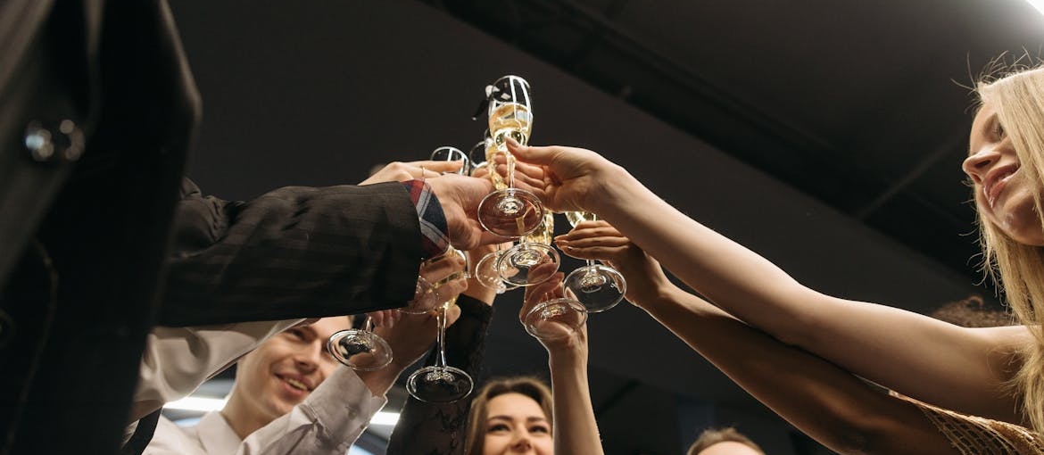 People celebrating and toasting at a work party.