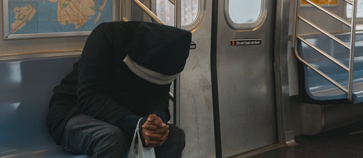 Sad man sitting on the subway.