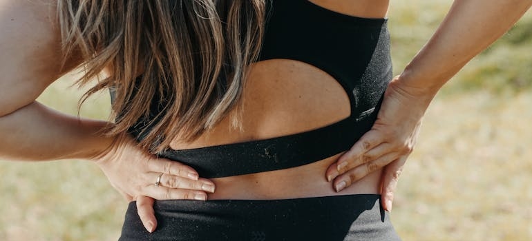 Woman stretching her sprained back.