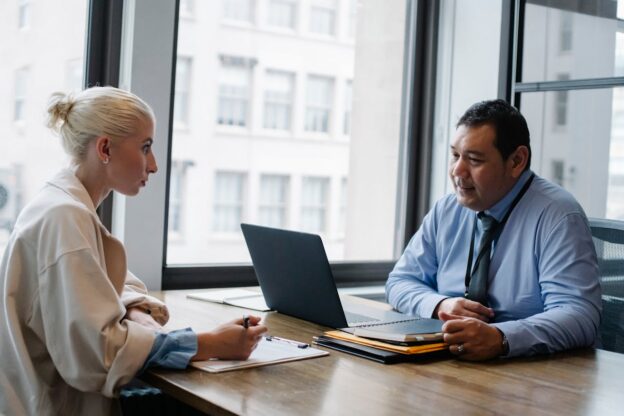 Woman talking with her boss while balancing work and recovery.