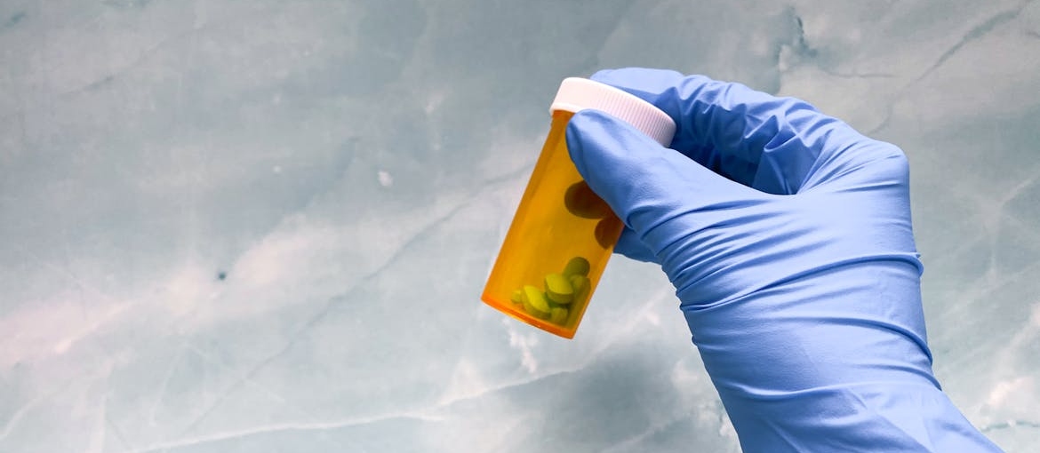 Doctor holding a bottle of pills.