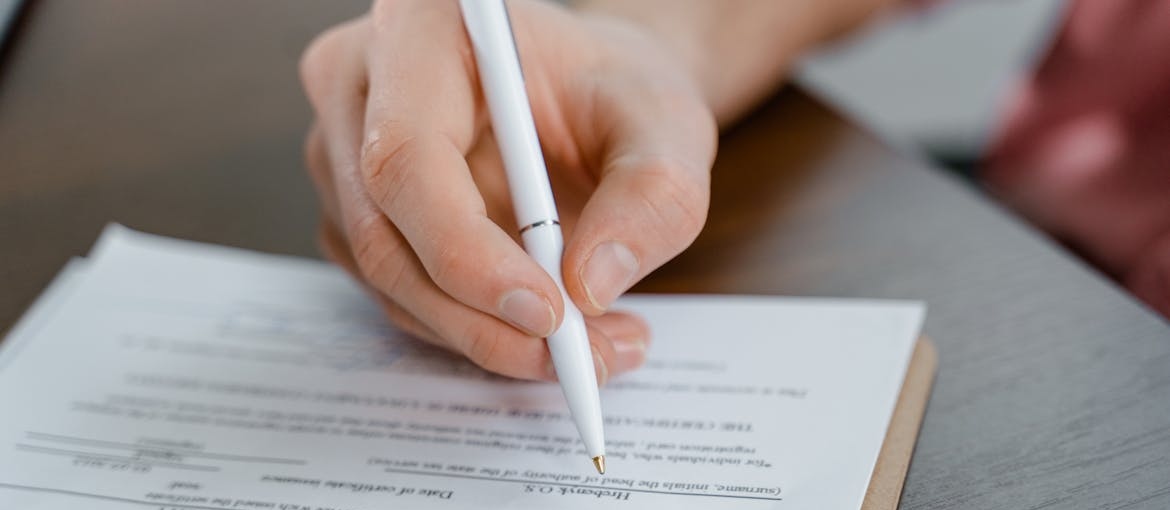 Person signing a confidentiality document.