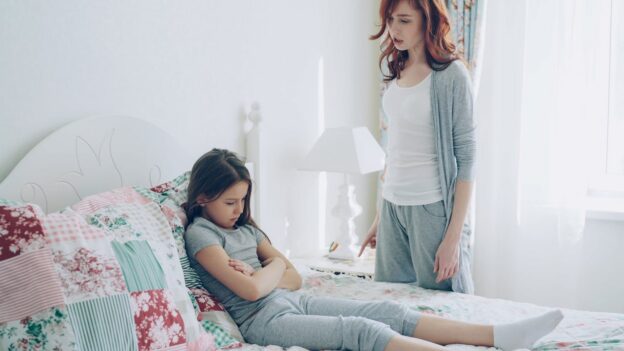 Mother trying to talk to her upset young daughter.